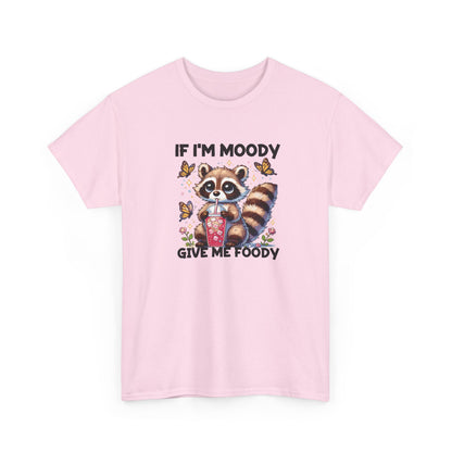Front view of a pink T-shirt featuring a raccoon graphic with food and the text "If I'm Moody, Give Me Foody." Part of the Vivid Divergence Sensory Friendly Unisex Tees Range.