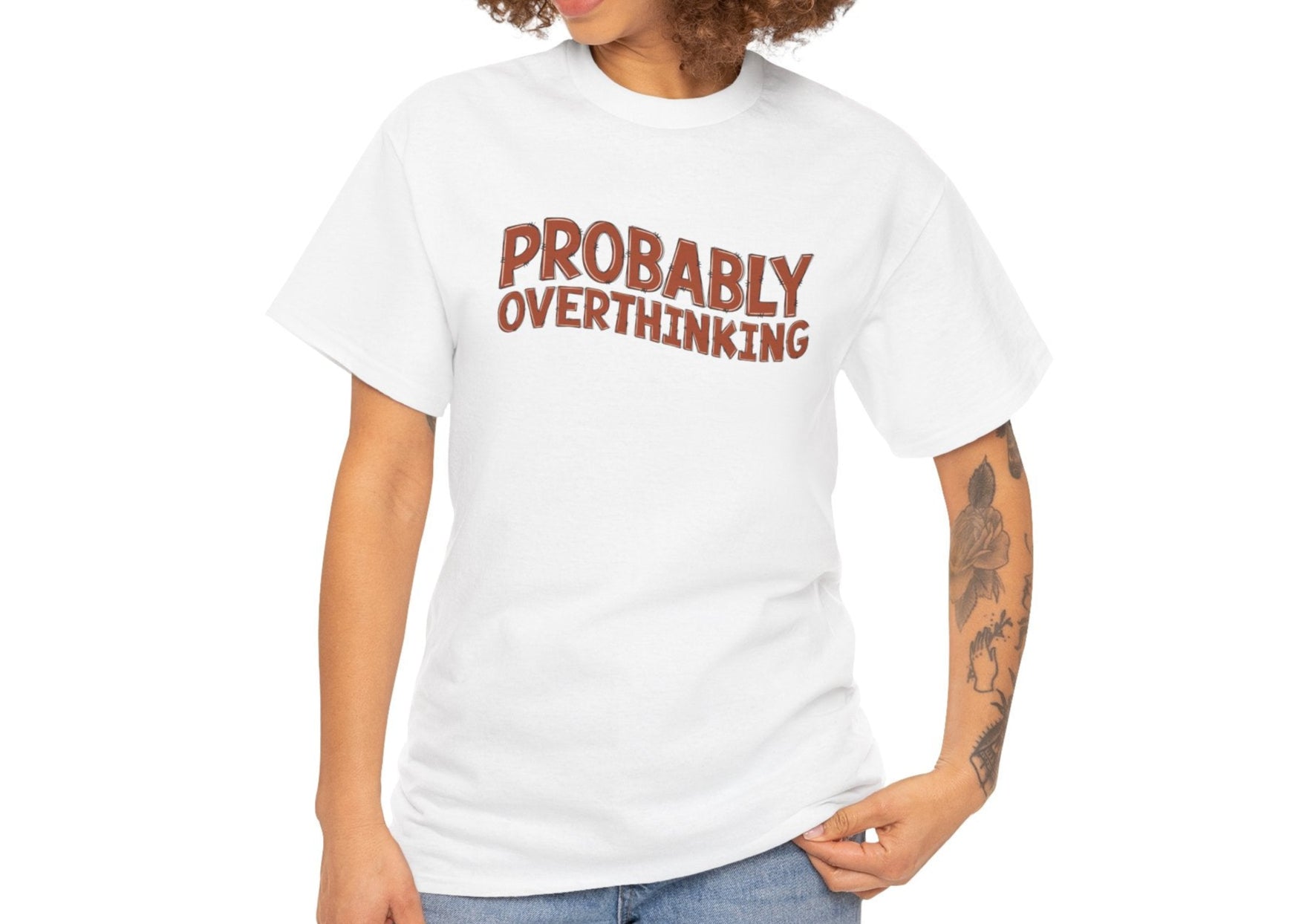 Woman with curly hair wearing a white "PROBABLY OVERTHINKING" T-shirt, smiling and posing casually. Part of the Vivid Divergence Sensory Friendly Unisex Tees Range.