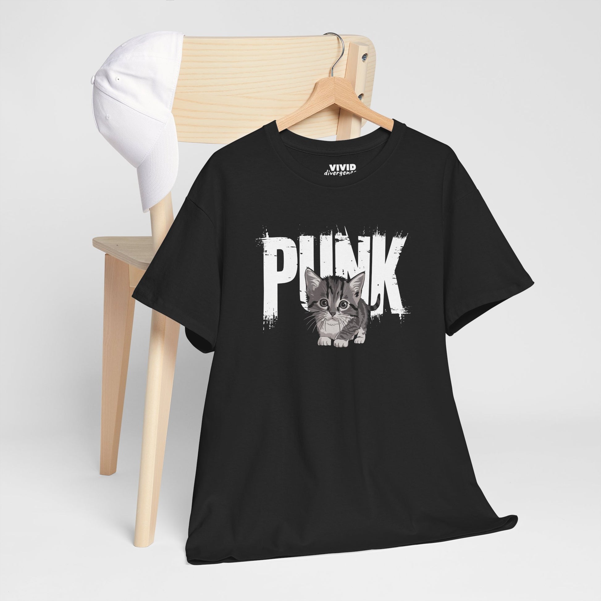 Black Punk Kitten T-shirt hanging on a wooden hanger, showing mohawked kitten design front and center. Cute chaos energy. Part of the Vivid Divergence Memewear Collection!
