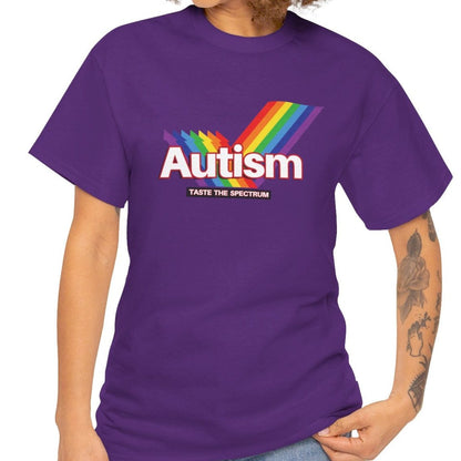 Side view of a purple T-shirt worn by a person, featuring the phrase "Autism" in a Skittles-inspired design and a rainbow graphic. Part of the Vivid Divergence Sensory Friendly Unisex Tees Range.
