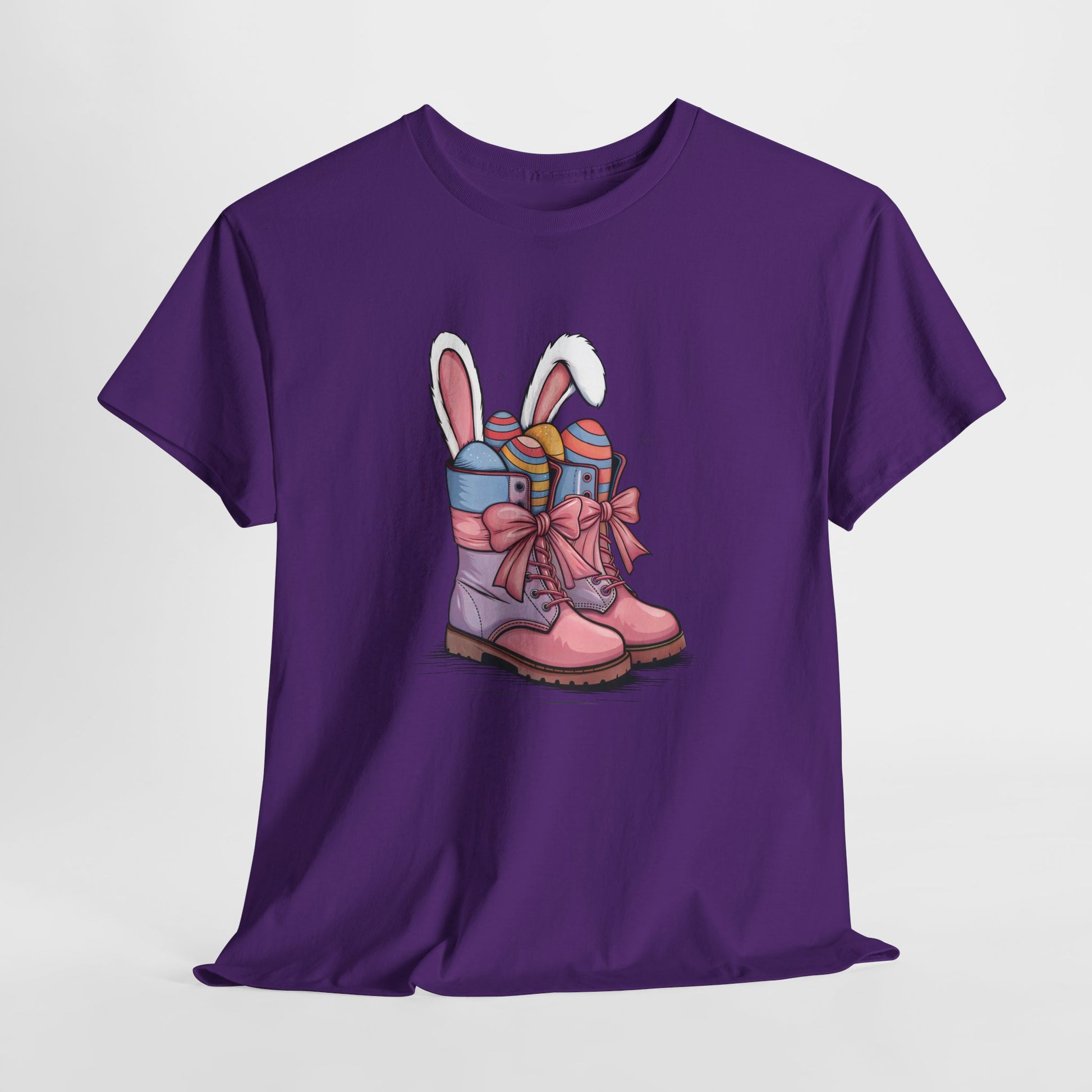 Purple T-shirt hanging, showcasing a cute cowgirl boots design with bunny ears and colorful Easter eggs, a fun holiday outfit. Hop into the season in style and shop Easter shirts online today!