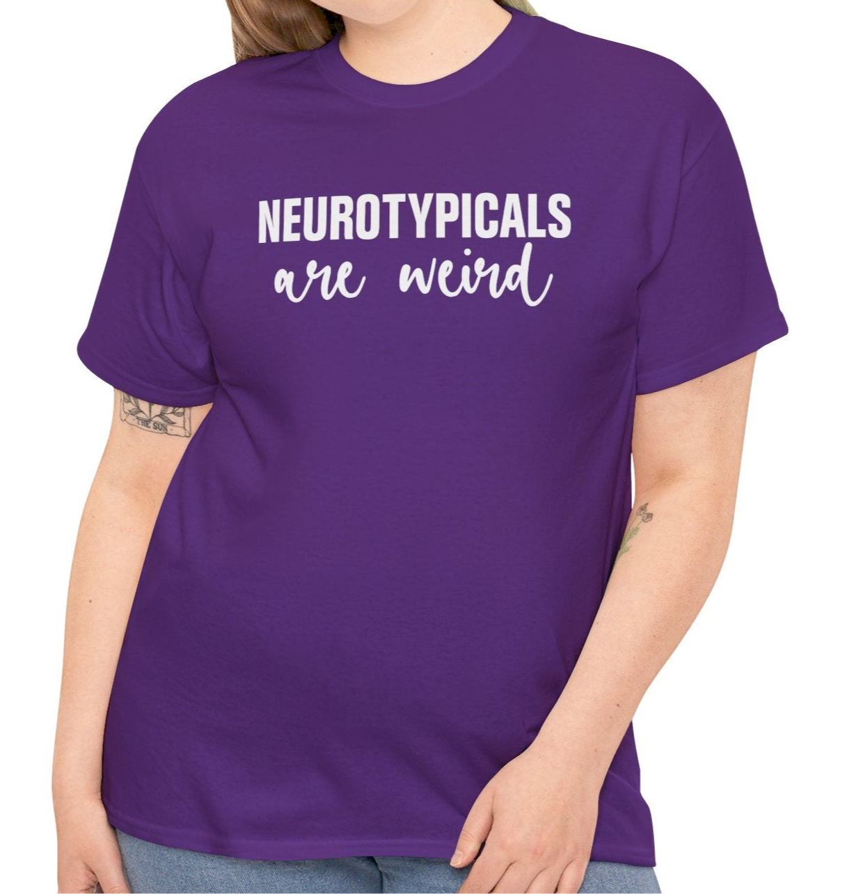 Model wearing a purple T-shirt with "Neurotypicals Are Weird" in bold white text. Part of the Vivid Divergence Sensory Friendly Unisex Tees Range.