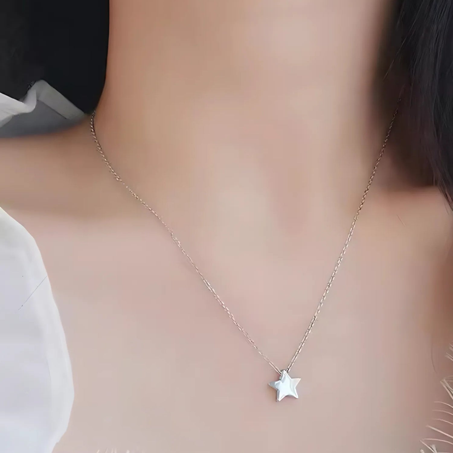 Radiant Star Necklace worn around the neck, showcasing its elegant silver star pendant.