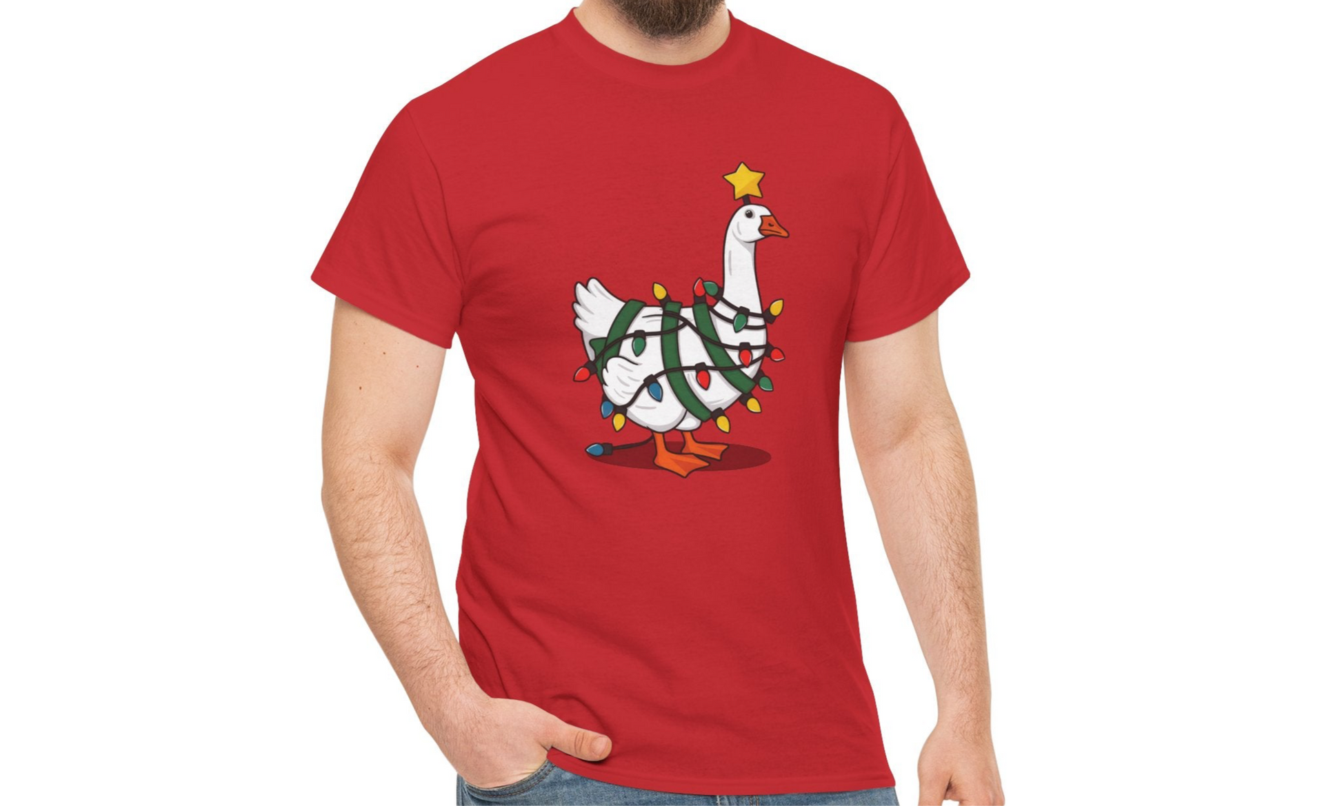 Model wearing a red T-shirt featuring a festive illustration of a goose wearing a Santa hat and stringing Christmas lights, with the text "Goose on the Loose." Part of the Vivid Divergence Sensory Friendly Unisex Tees Range.