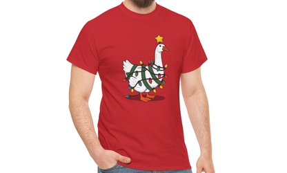 Model wearing a red T-shirt featuring a festive illustration of a goose wearing a Santa hat and stringing Christmas lights, with the text "Goose on the Loose." Part of the Vivid Divergence Sensory Friendly Unisex Tees Range.