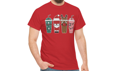 Model wearing a red T-shirt featuring a festive illustration of four iced coffee cups decorated with Christmas designs, styled in a cozy indoor setting. Part of the Vivid Divergence Sensory Friendly Unisex Tees Range.