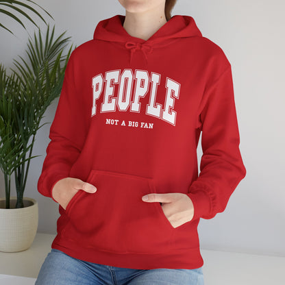 Model wearing a red hoodie featuring the text "People, Not a Big Fan" in bold collegiate-style white lettering. Part of the Vivid Divergence Sensory Friendly Unisex Hoodie Range.