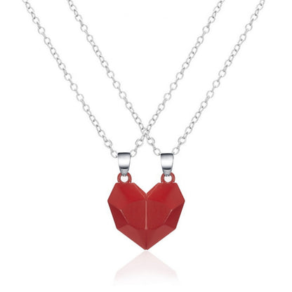 Matching red heart-shaped necklaces on silver chains, perfect for couples or mother-daughter jewelry.