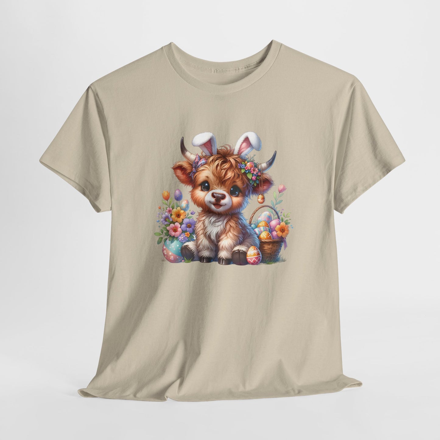 Sand T-shirt hanging, featuring a rustic Highland cow with Easter decorations, perfect for country-style holiday wear. Hop into the season in style and shop Easter shirts online today!