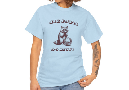 Side view of a light blue T-shirt featuring the text "All Panic No Disco" and a raccoon illustration, worn by a model. Part of the Vivid Divergence Sensory Friendly Unisex Tees Range.