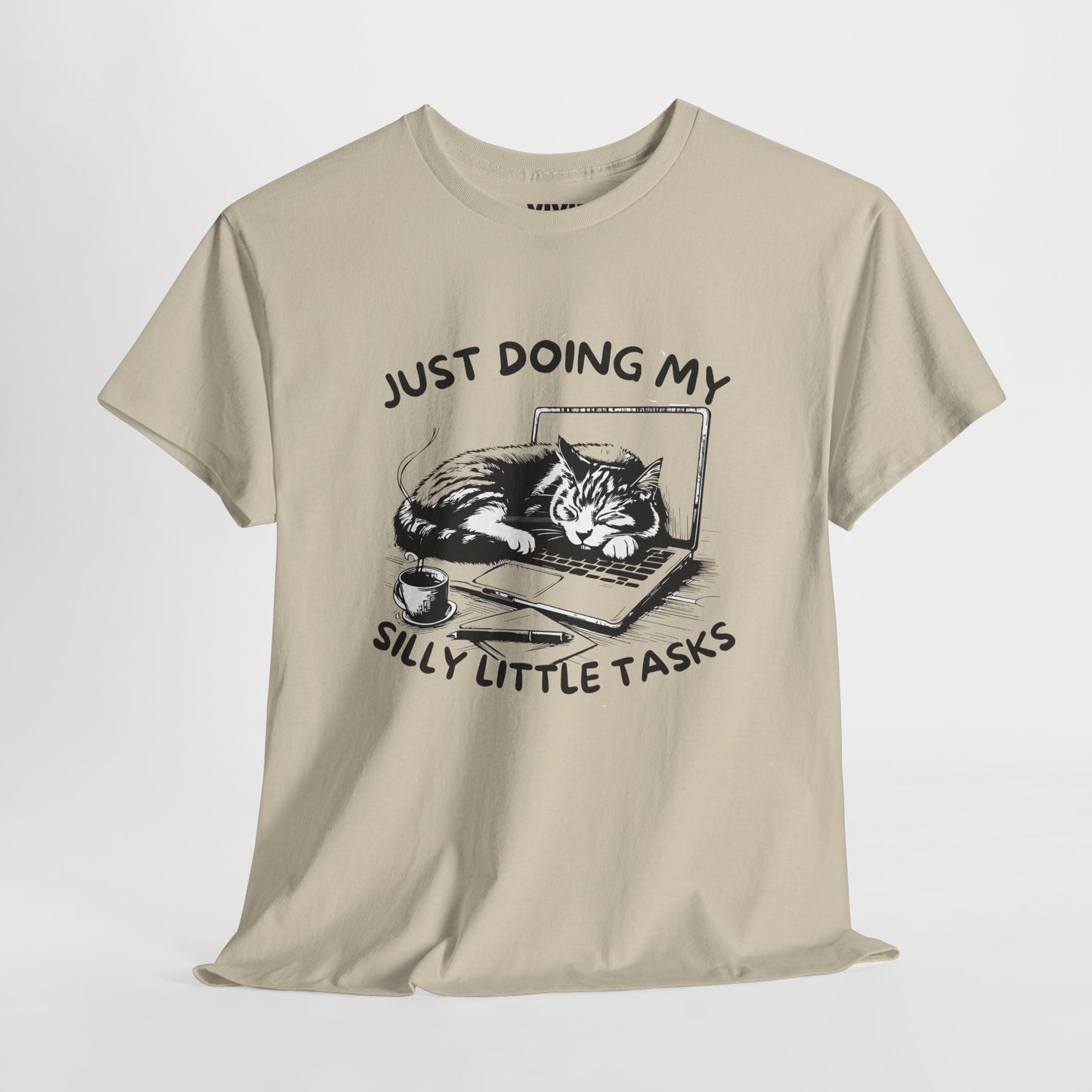 Beige meme T-shirt with laptop cat graphic hanging on a hanger. Doing the least in the cutest way. Part of the Vivid Divergence Memewear Collection!
