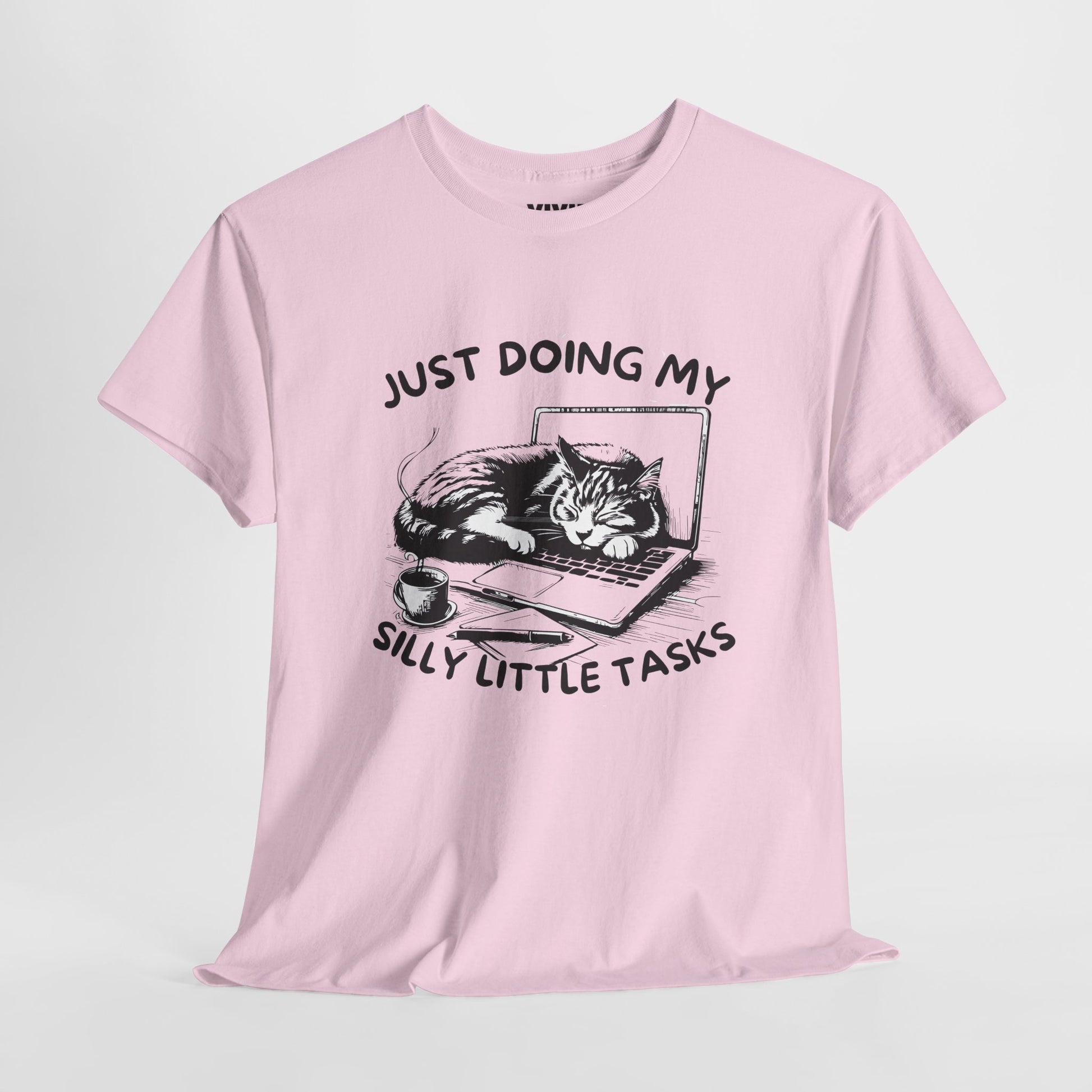 Light Pink meme T-shirt with laptop cat graphic hanging on a hanger. Doing the least in the cutest way. Part of the Vivid Divergence Memewear Collection!