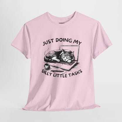 Light Pink meme T-shirt with laptop cat graphic hanging on a hanger. Doing the least in the cutest way. Part of the Vivid Divergence Memewear Collection!