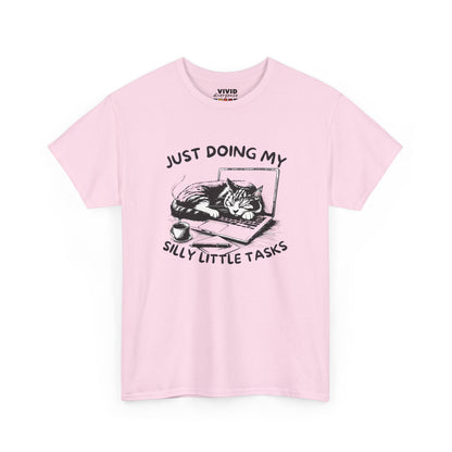 Front view of pastel pink T-shirt featuring cat-on-laptop design with hand-drawn charm. Soft, cozy procrastination energy. Part of the Vivid Divergence Memewear Collection!
