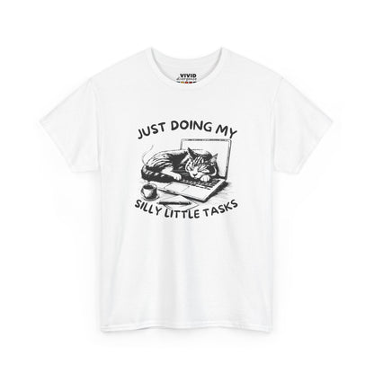  Front view of white T-shirt featuring a black and white illustration of a cat sprawled across a laptop with the text “Just Doing My Silly Little Tasks.” Cat priorities only. Part of the Vivid Divergence Memewear Collection!
