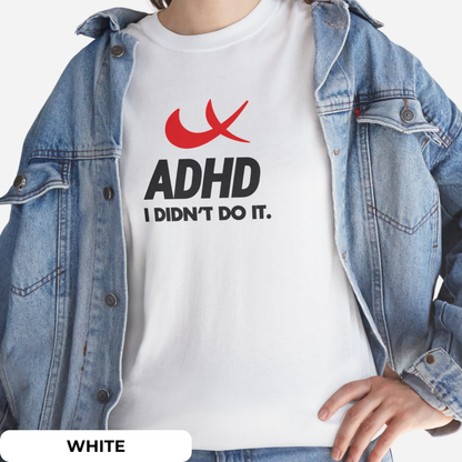 Styled look featuring a white T-shirt with "ADHD I Didn't Do It" phrase and red swoosh parody of the Nike symbol, worn under a denim jacket. Part of the Vivid Divergence Sensory Friendly Unisex Tees Range