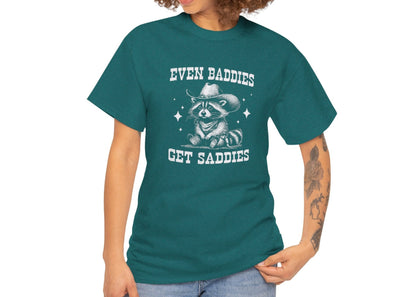 Model wearing a teal T-shirt with the text "Even Baddies Get Saddies" and a crying eye graphic, casual fit. Part of the Vivid Divergence Sensory Friendly Unisex Tees Range.