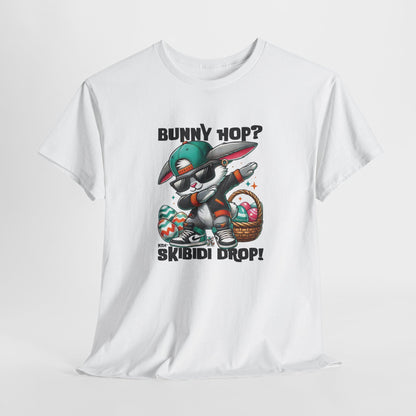Hanging view of a viral meme-inspired T-shirt in white. Features a graphic design of a dabbing Easter bunny with text that says, "Bunny Hop? Nah, Skibidi Drop!" A fun, bold shirt radiating skibidi sigma rizz energy for Easter. Part of the Vivid Divergence Sensory Friendly Unisex Tees Range.