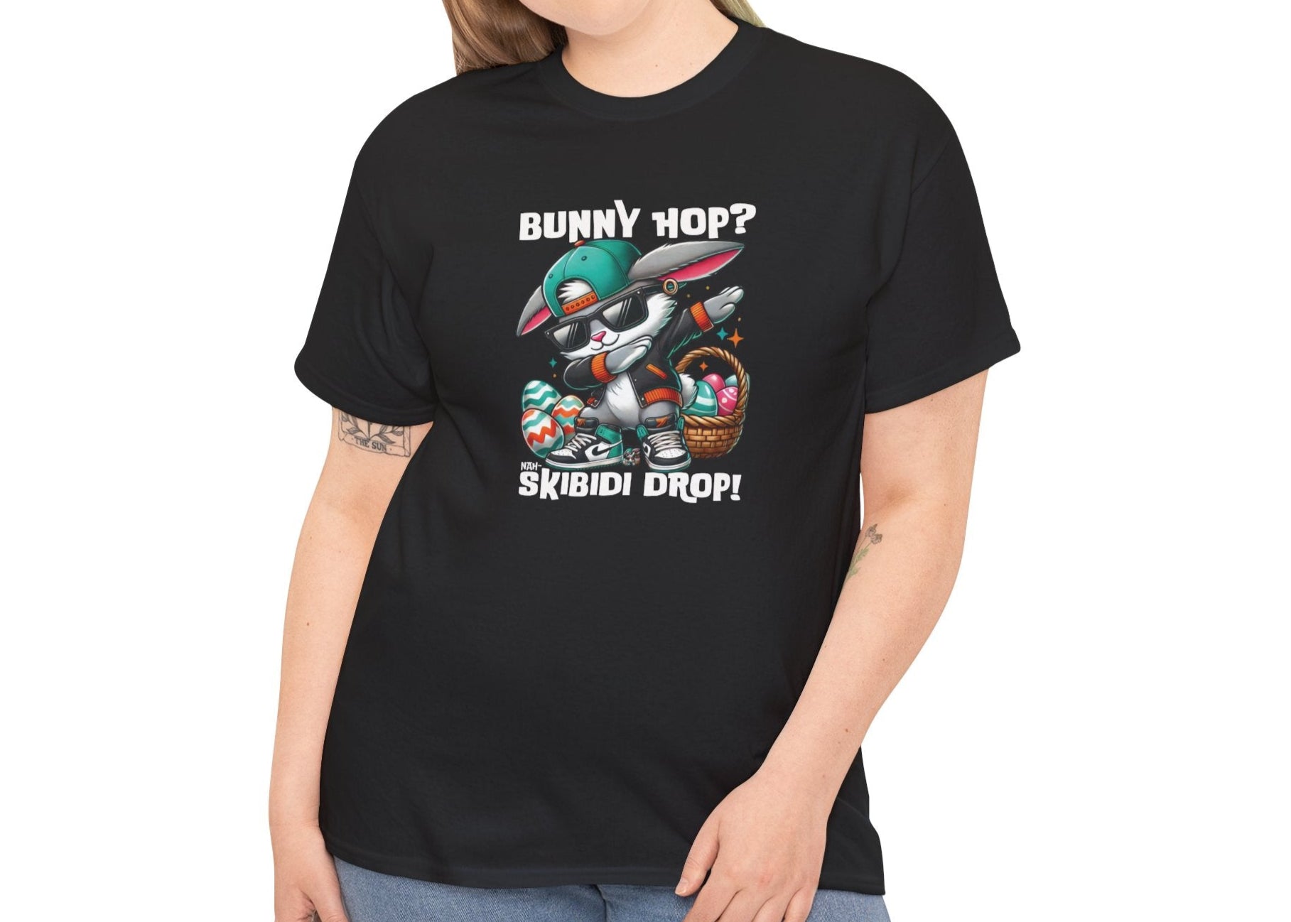 Modeled view of a viral meme-inspired T-shirt in black. A sleek, eye-catching shirt with a dabbing Easter bunny and "Bunny Hop? Nah, Skibidi Drop!" text. Packed with viral skibidi sigma rizz energy. Part of the Vivid Divergence Sensory Friendly Unisex Tees Range.