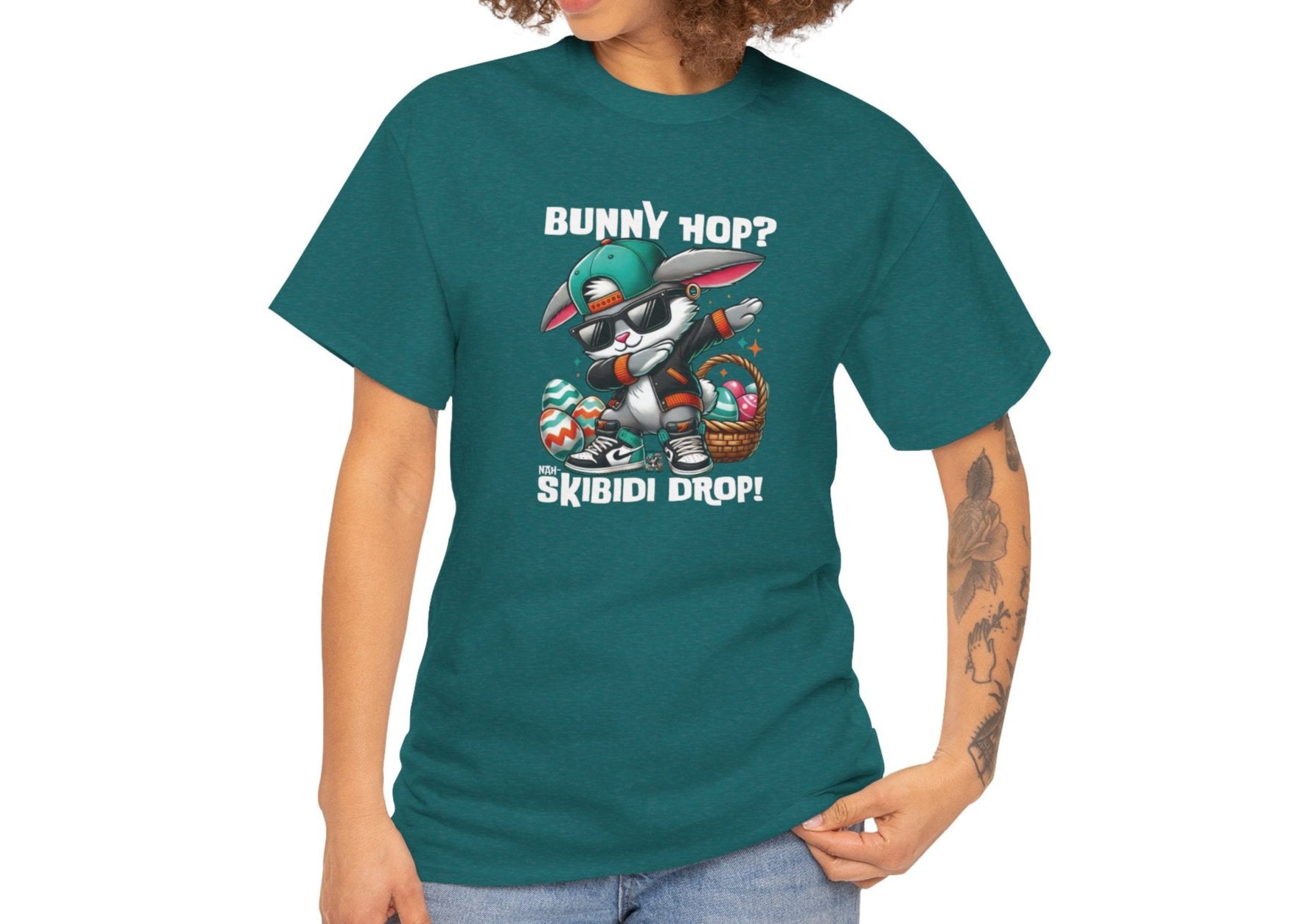 Modeled view of a viral meme-inspired T-shirt in dark teal. A cool and quirky skibidi rizz energy tee featuring a dabbing Easter bunny and "Bunny Hop? Nah, Skibidi Drop!" A bold Easter pick. Part of the Vivid Divergence Sensory Friendly Unisex Tees Range.
