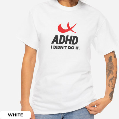 Side view of a white T-shirt featuring the phrase "ADHD I Didn't Do It" with a red swoosh parody of the Nike symbol. Part of the Vivid Divergence Sensory Friendly Unisex Tees Range.