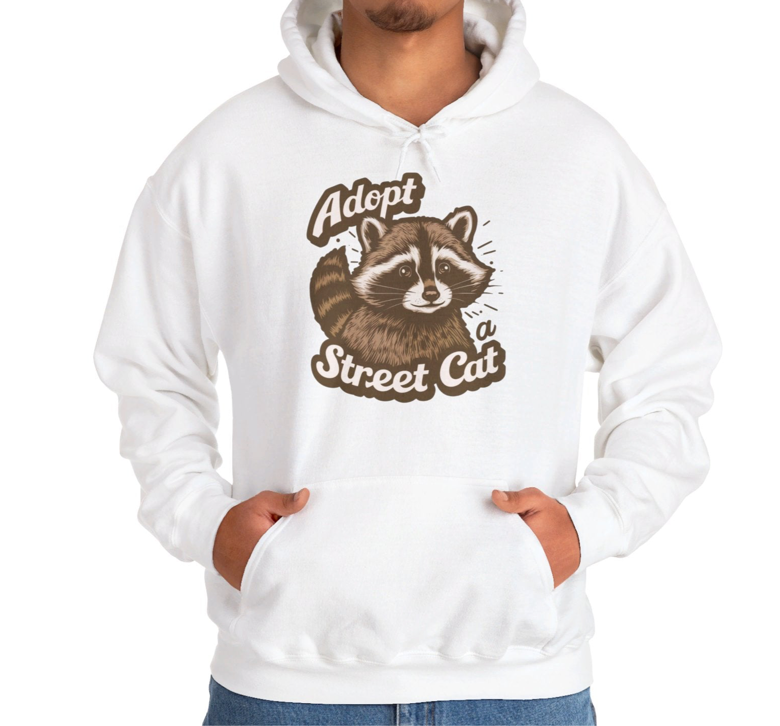 Model wearing a white hoodie with the text "Adopt a Street Cat" and a cartoon illustration of a raccoon holding a cup. Part of the Vivid Divergence Sensory Friendly Unisex Hoodie Range.
