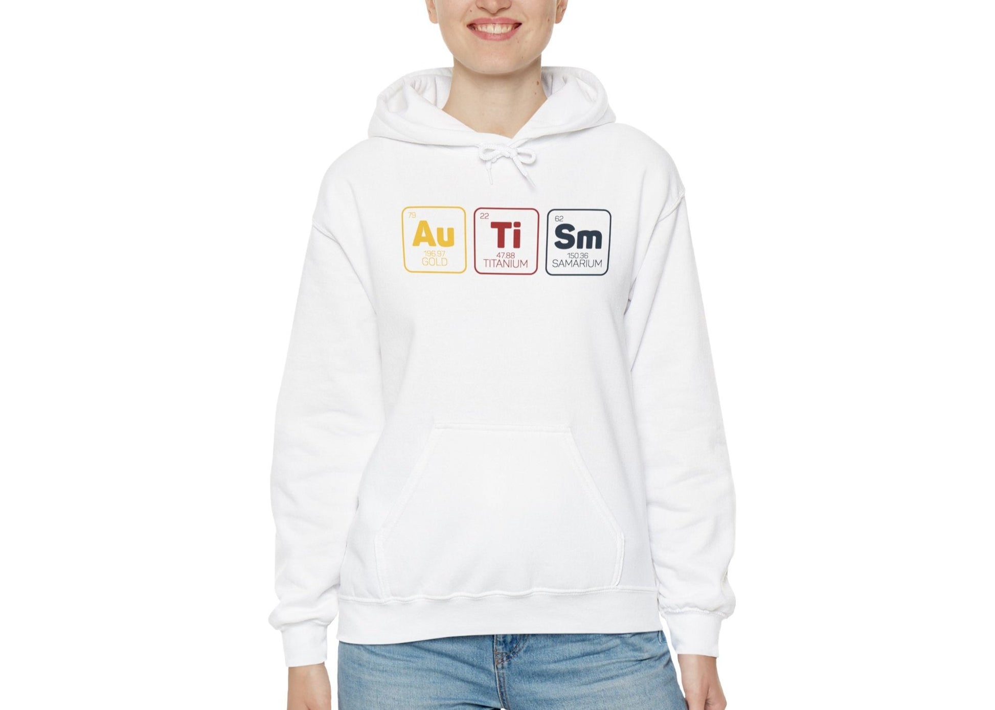Model wearing a white hoodie featuring a periodic table design spelling "Autism" with elements Au, Ti, and Sm in colored boxes. Part of the Vivid Divergence Sensory Friendly Unisex Hoodie Range.