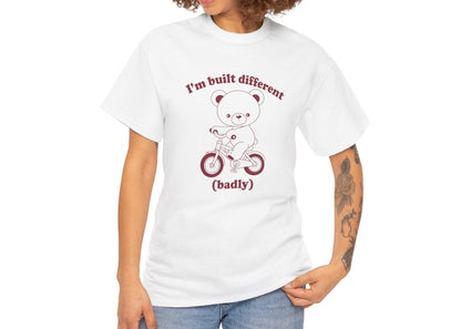Model wearing a white T-shirt with the "Built Different (Badly)" bear design. Part of the Vivid Divergence Sensory Friendly Unisex Tees Range.