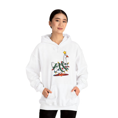 Model wearing a white hoodie featuring a festive illustration of a goose wearing a Santa hat and stringing Christmas lights, with the text "Goose on the Loose." Part of the Vivid Divergence Sensory Friendly Unisex Hoodie Range.