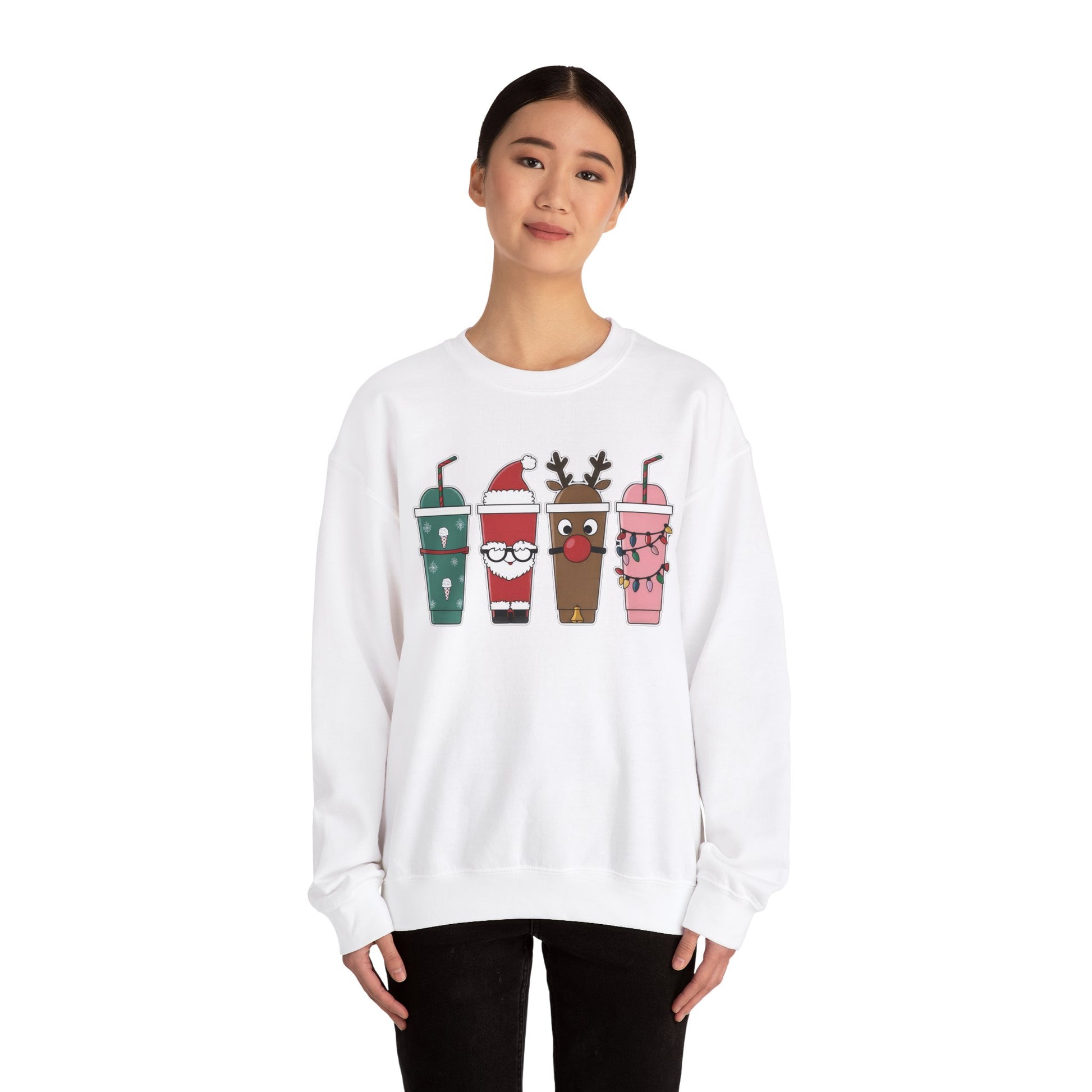 Model wearing a white sweatshirt featuring a festive illustration of four iced coffee cups decorated with Christmas designs, including reindeer, Santa, and holiday patterns. Part of the Vivid Divergence Sensory Friendly Unisex Sweater Jumper Range.