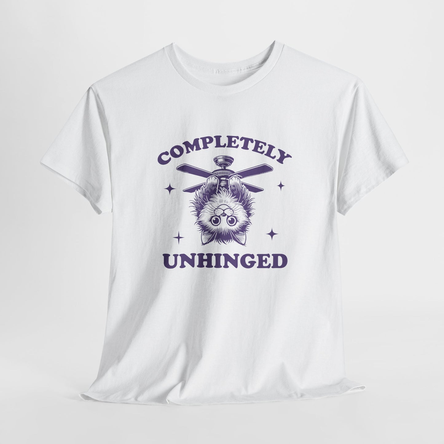 Hanging white T-shirt featuring "Completely Unhinged" text with a cat hanging upside down from a ceiling fan in navy blue-tone design. Part of the Vivid Divergence Sensory Friendly Unisex Tees Range.