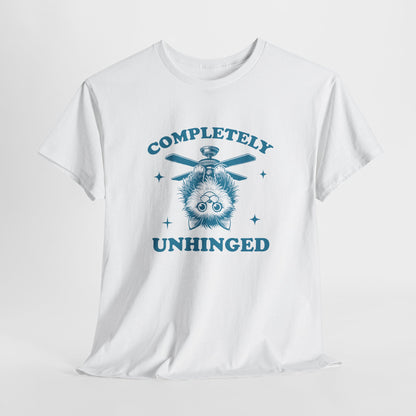 Hanging white T-shirt featuring "Completely Unhinged" text with a cat hanging upside down from a ceiling fan. Part of the Vivid Divergence Sensory Friendly Unisex Tees Range.