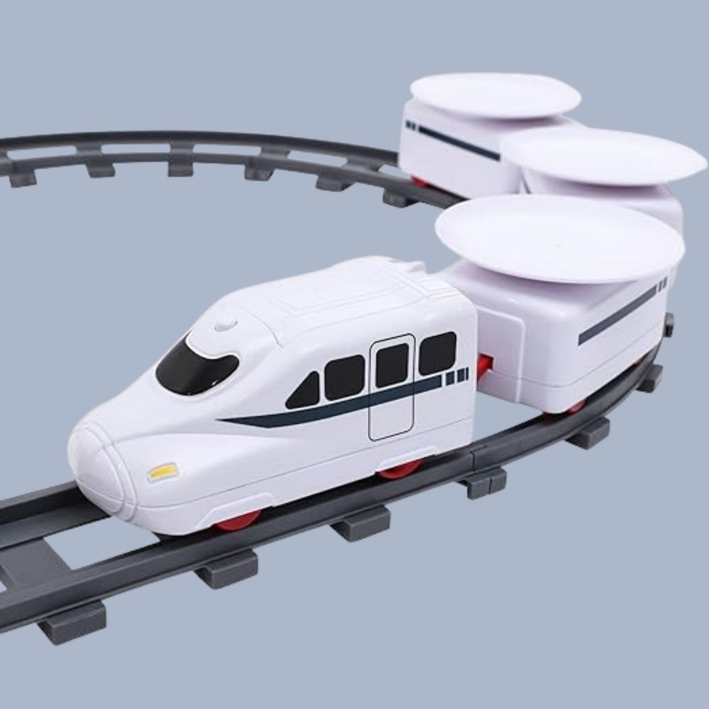 A white electric train with three cart attachments running on a circular track. Perfect for delivering snacks and treats. Part of the Tasty Tracks Ultimate Mealtime Electric Train Adventure.
