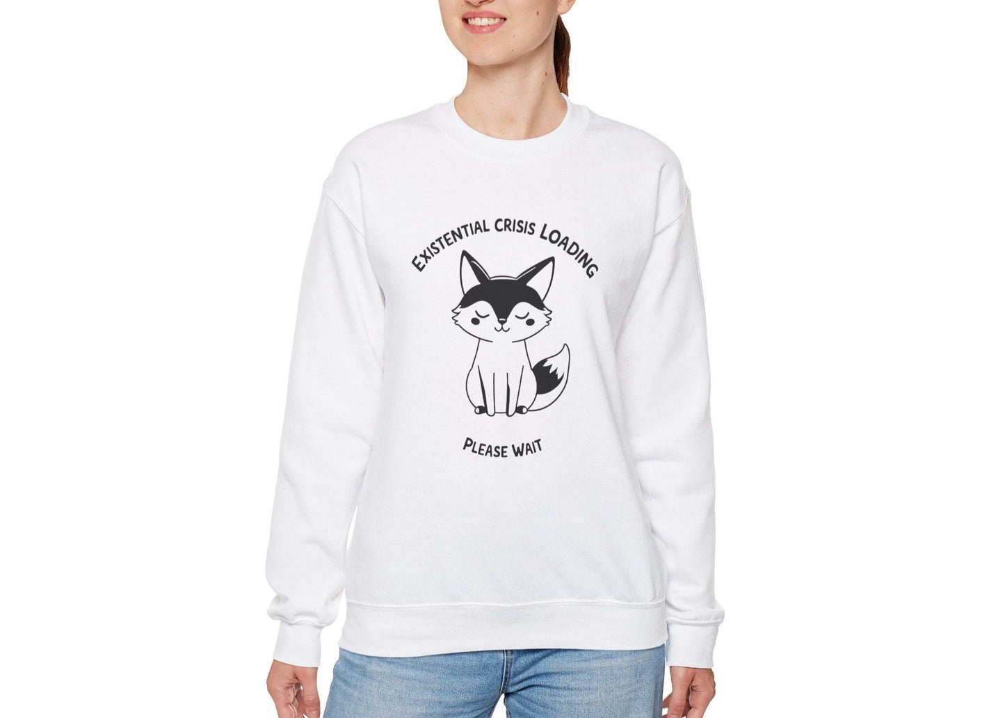 Model wearing a white sweater jumper with the text "Existential Crisis Loading, Please Wait" and a cartoon fox illustration. Part of the Vivid Divergence Sensory Friendly Unisex Sweater Jumper Range.