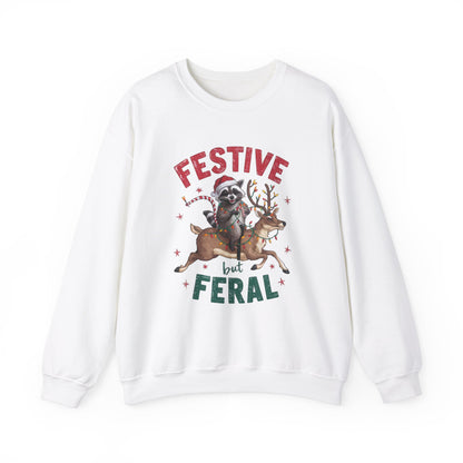 Front view of a white sweatshirt featuring a festive illustration of a raccoon (trash panda) holding Christmas lights and the text "Festive but Feral." Part of the Vivid Divergence Sensory Friendly Unisex Sweater Jumper Range.