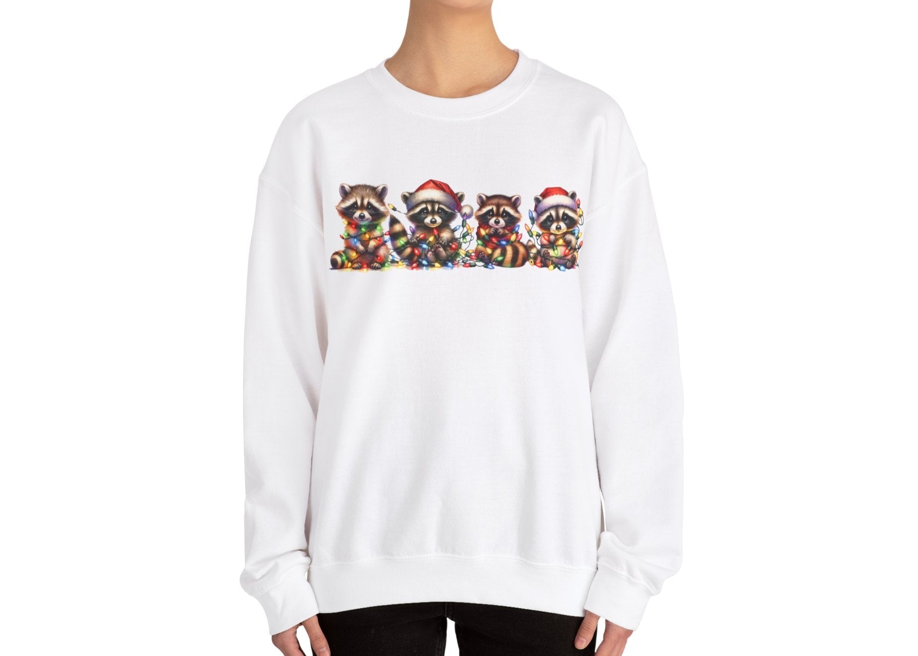 Model wearing a beige sweatshirt featuring a festive illustration of raccoons in Christmas attire causing holiday chaos. Part of the Vivid Divergence Sensory Friendly Unisex Sweater Jumper Range.