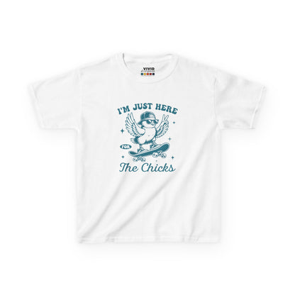 White kids' T-shirt showcasing a fun "I'm Just Here for the Chicks" graphic with a cheerful chick, a great Easter outfit choice. Hop into the season in style and shop Easter shirts online today!