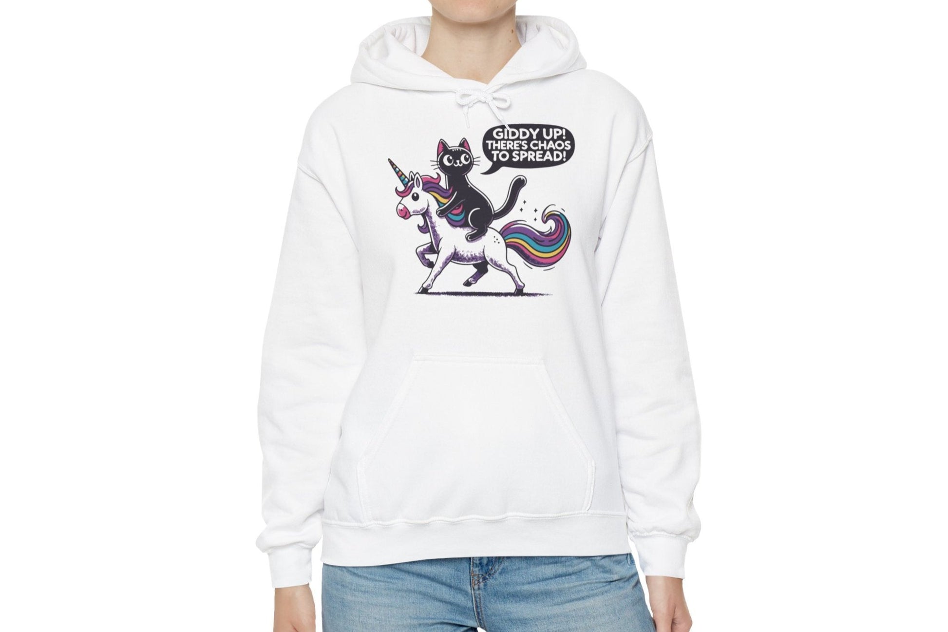 Model wearing a white hoodie featuring the text "Giddy Up, There’s Chaos to Spread" and a cartoon illustration of a cat riding a unicorn. Part of the Vivid Divergence Sensory Friendly Unisex Hoodie Range.