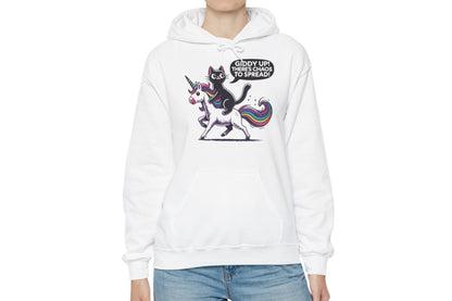 Model wearing a white hoodie featuring the text "Giddy Up, There’s Chaos to Spread" and a cartoon illustration of a cat riding a unicorn. Part of the Vivid Divergence Sensory Friendly Unisex Hoodie Range.