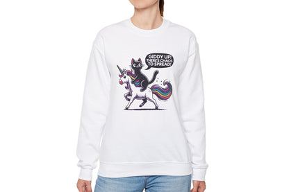 Model wearing a white sweater jumper featuring a cartoon cat riding a unicorn with rainbow mane and the text "Giddy Up, There's Chaos to Spread." Part of the Vivid Divergence Sensory Friendly Unisex Sweater Jumper Range.