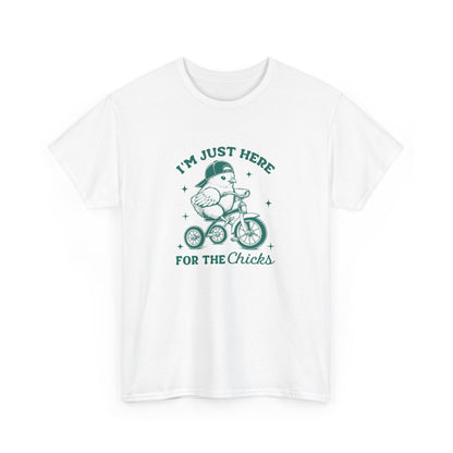 White Easter T-shirt featuring a playful chick riding a bicycle with "I'm Just Here for the Chicks" text, a fun and festive design. Hop into the season in style and shop Easter shirts online today!