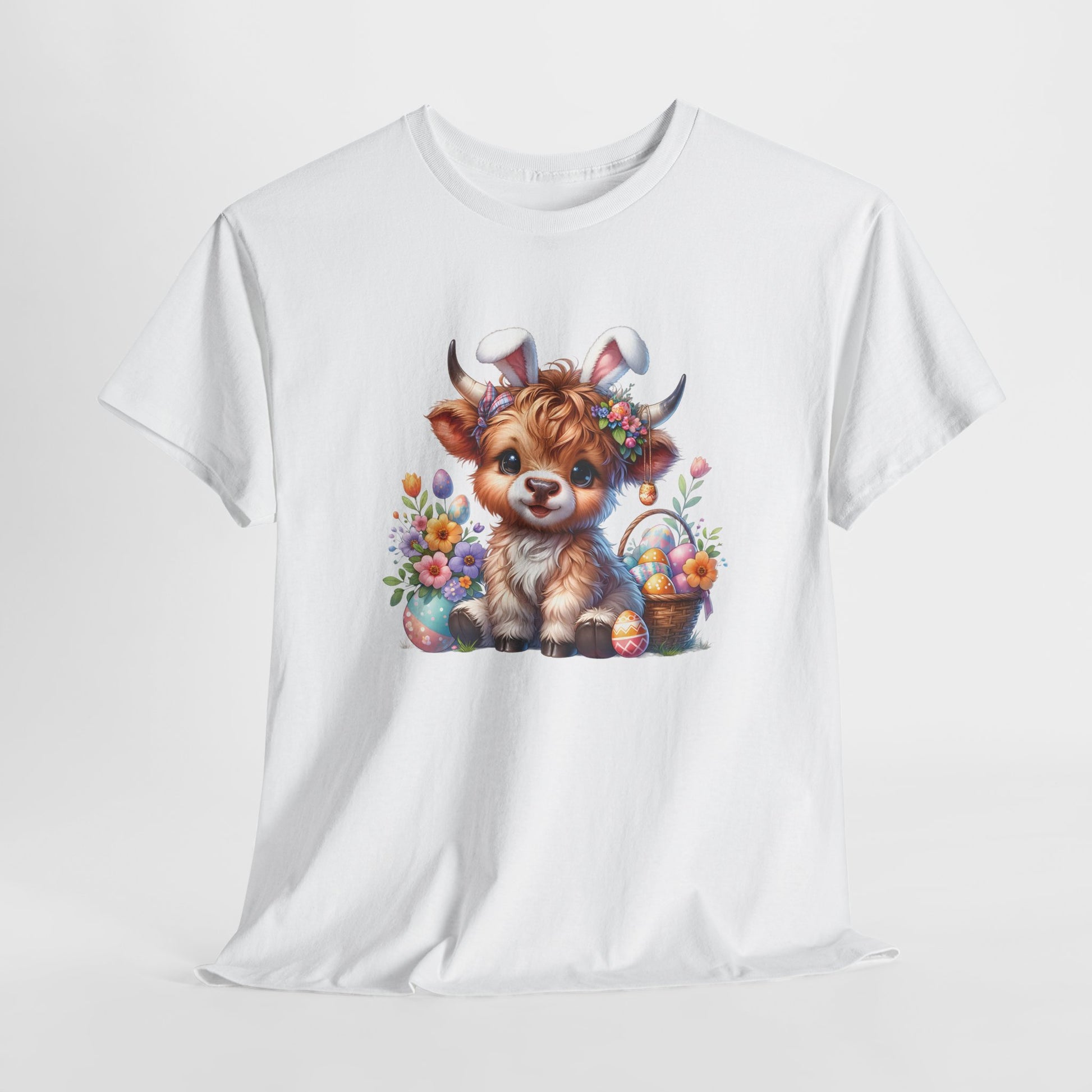 White T-shirt hanging, featuring a Highland cow with bunny ears and colorful Easter eggs, a perfect blend of farm charm and holiday fun. Hop into the season in style and shop Easter shirts online today!