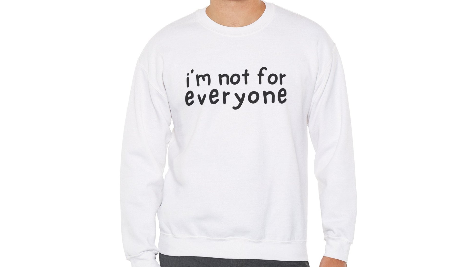 Model wearing a white sweater jumper with the text "I'm Not For Everyone" in bold black lettering. Part of the Vivid Divergence Sensory Friendly Unisex Sweater Jumper Range.