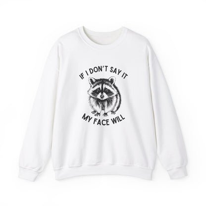 Front view of a white sweatshirt featuring a raccoon graphic with the text "If I Don't Say It, My Face Will." Part of the Vivid Divergence Sensory Friendly Unisex Sweater Jumper Range.