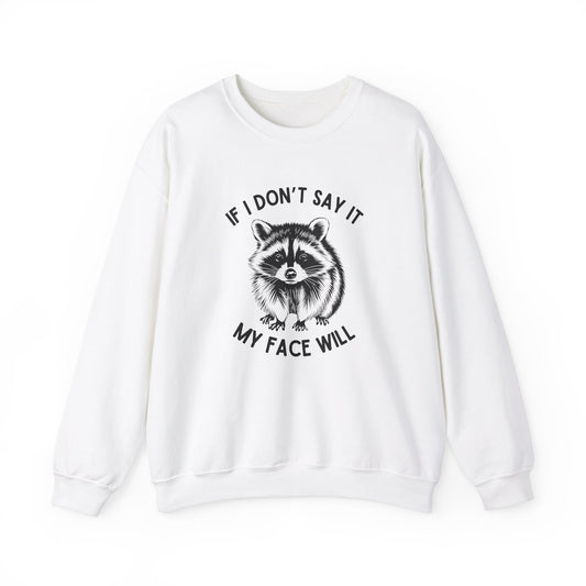 Front view of a white sweatshirt featuring a raccoon graphic with the text "If I Don't Say It, My Face Will." Part of the Vivid Divergence Sensory Friendly Unisex Sweater Jumper Range.