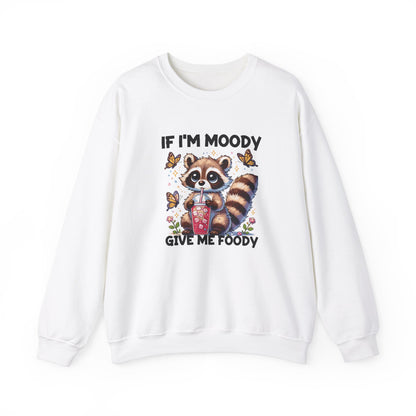 Front view of a white sweater jumper with the text "If I'm Moody, Give Me Foody" and a cartoon raccoon illustration holding snacks. Part of the Vivid Divergence Sensory Friendly Unisex Sweater Jumper Range.