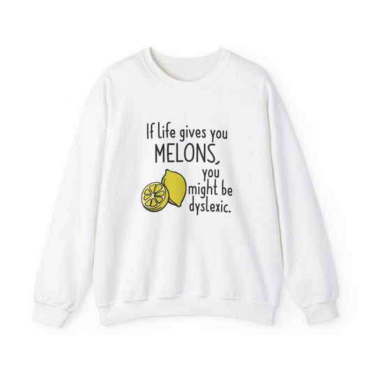 Front view of a white sweatshirt featuring an illustration of melons and the text "If Life Gives You Melons, You Might Be Dyslexic." Part of the Vivid Divergence Sensory Friendly Unisex Sweater Jumper Range.