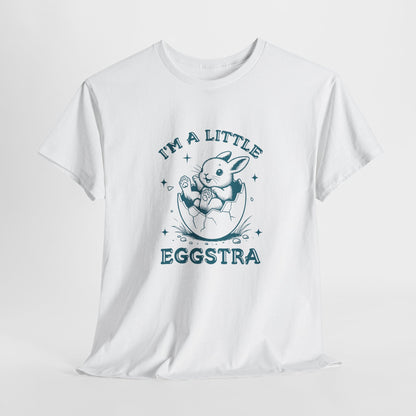 White Easter T-shirt hanging, featuring a cute bunny and "I'm A Little Eggstra" text in a blue design, perfect for a fun holiday look. Hop into the season in style and shop Easter shirts online today!