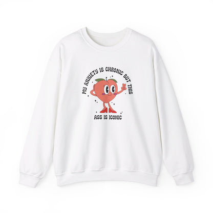 Front view of a white sweater jumper with the text "My anxiety is chronic but this ass is iconic" and a cartoon peach illustration. Part of the Vivid Divergence Sensory Friendly Unisex Sweater Jumper Range.