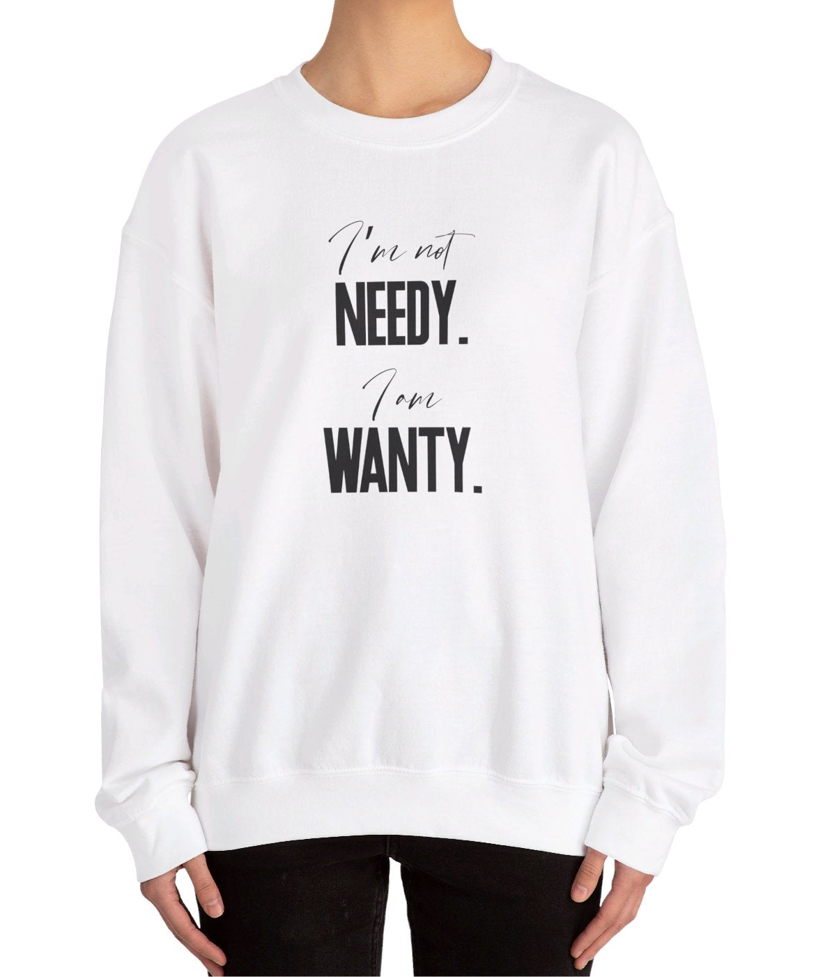 Model wearing a white sweatshirt featuring the phrase "I'm not NEEDY. I'm just WANTY." in bold black text. Part of the Vivid Divergence Sensory Friendly Sweatshirt Range.